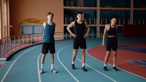 three athletes in a running track