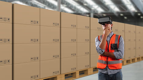 caucasian man wearing an orange high vest and hat with 3d virtual googles in a warehouse area