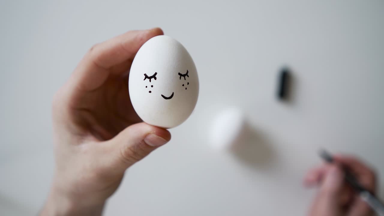 A master class on coloring eggs. Close up view painting Easter eggs with marker