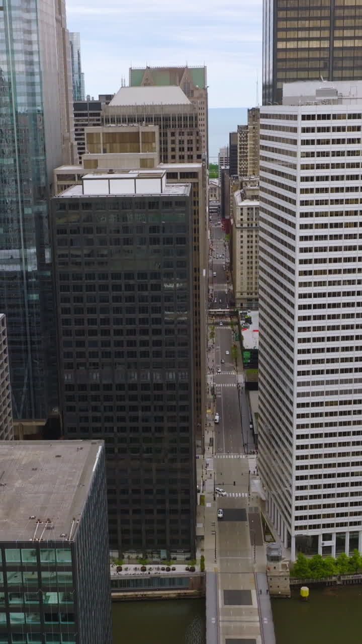 Huge massive building standing close to each other. Densely built area of modern Chicago, Illinois. Top view. Vertical video