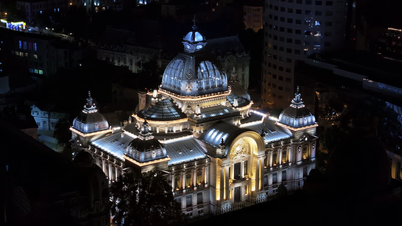 Aerial drone view of the Palace of the Deposits and Consignments illuminated in Bucharest, Romania at night