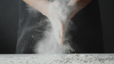 chef clapping hands with flour