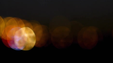 animation of winter landscape with houses over light spots on black background