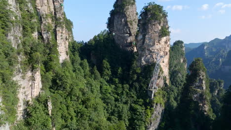 aerial view ascending in front of gondolas to huangshizhai in zhangjiajie, china