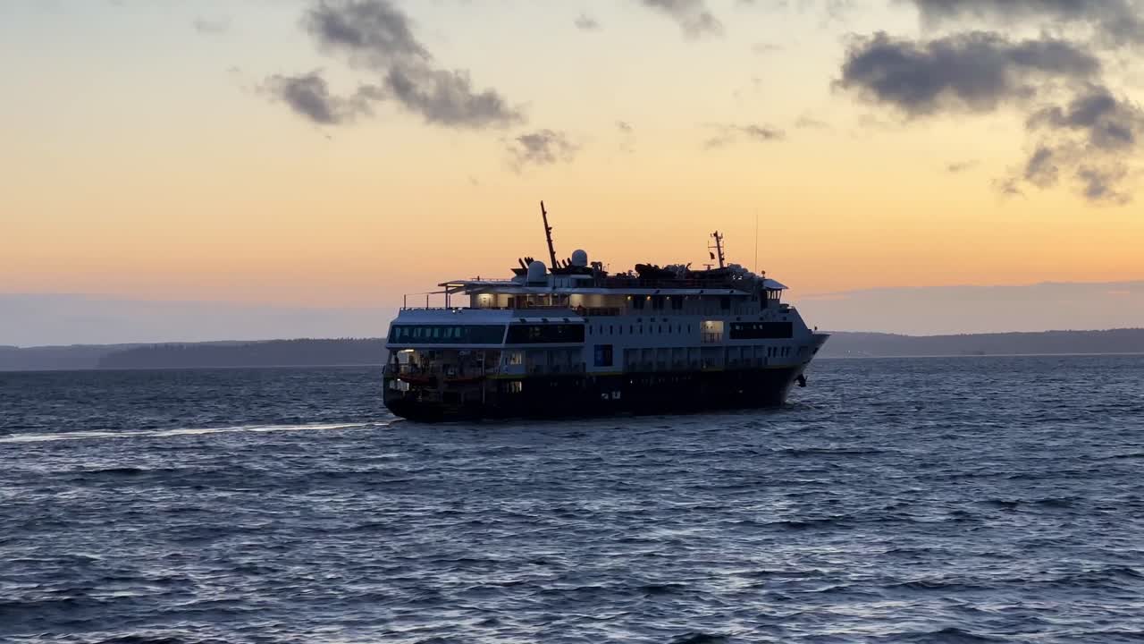Washington, Seattle yakınlarındaki gün batımında National Geographic bilim gemisinin elde çekilmiş takip çekimi. 4K