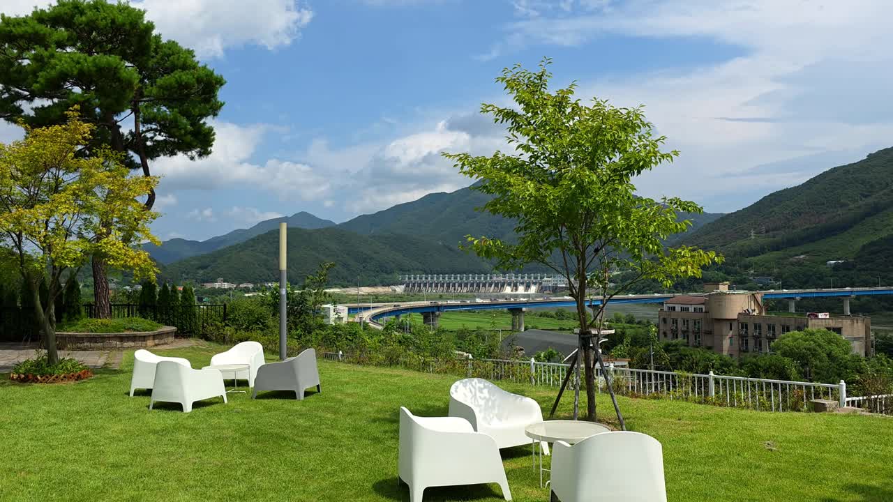 Sweeping panoramic shot reveals the stunning scenery of Gapyeong from a hillside cafe, showcasing the Bukhangang River and majestic Hwayasan Mountain