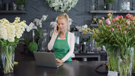 woman talking phone in floral shop