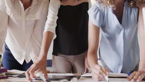 Midsection-of-diverse-female-colleagues-in-discussion-in-casual-office-meeting,-slow-motion