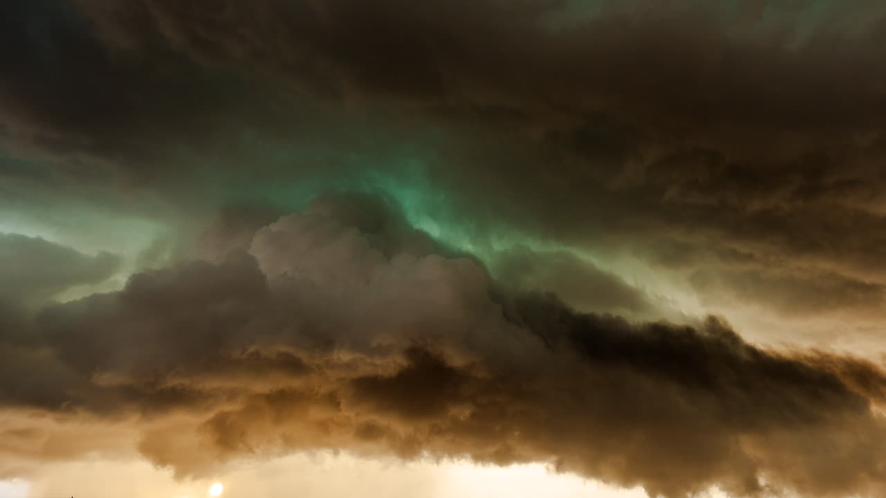 Dark storm cloud formations traveling across the sky with strong visual momentum
