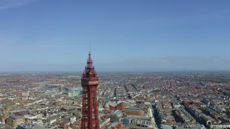 Stunning-aerial-view,-footage-of-Blackpool-Tower-from-the-sea-of-the-award-winning-Blackpool-beach,-A-very-popular-seaside-tourist-location-in-England-,-United-Kingdom,-UK