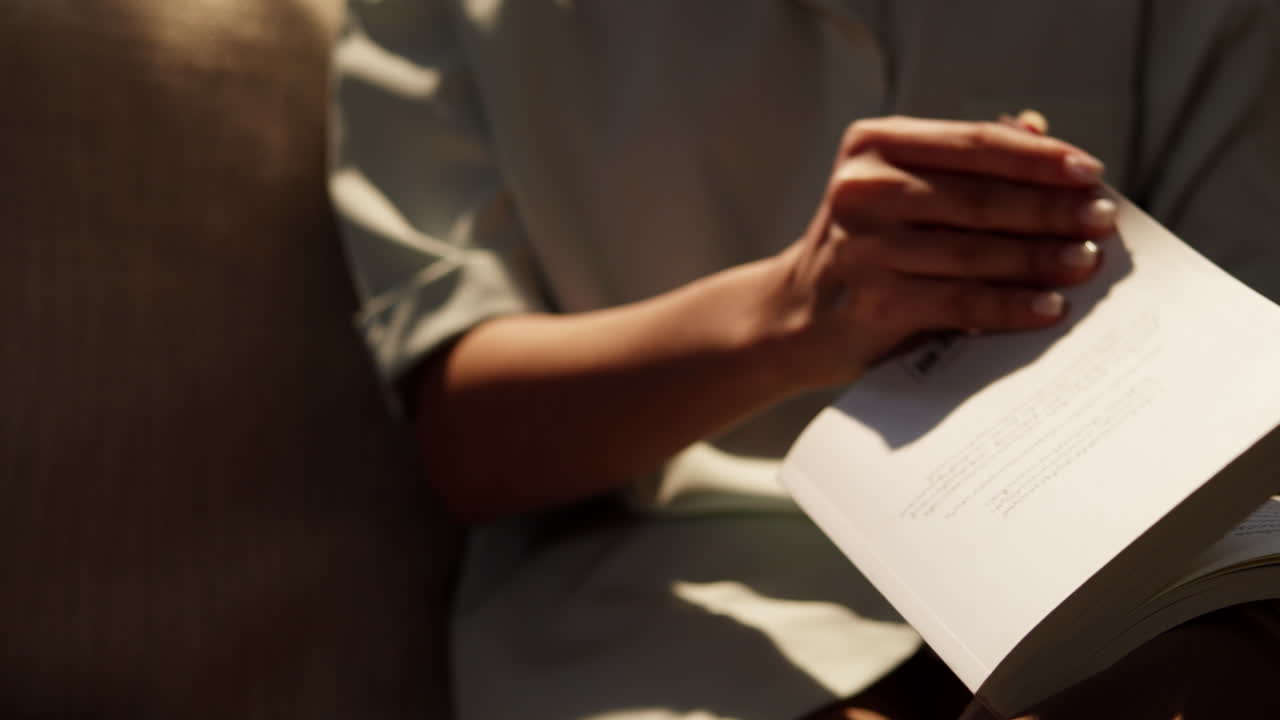 A person deeply engaged in reading surrounded by a tranquil atmosphere.