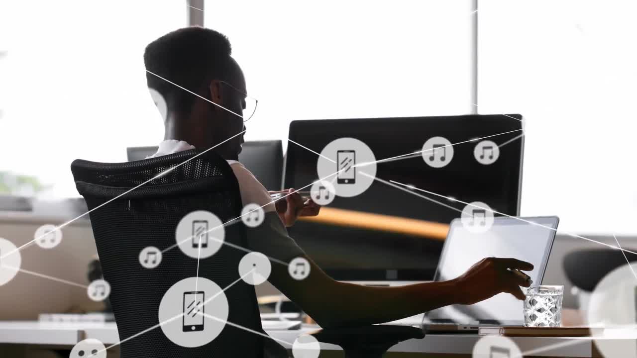 Animation of network of connections with icons over businessman using laptop