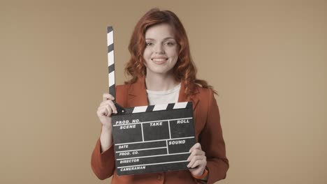 woman holding clapperboard