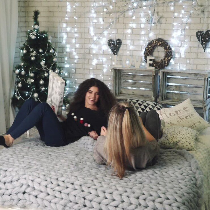 Ragazze che fanno una battaglia di cuscini a Natale