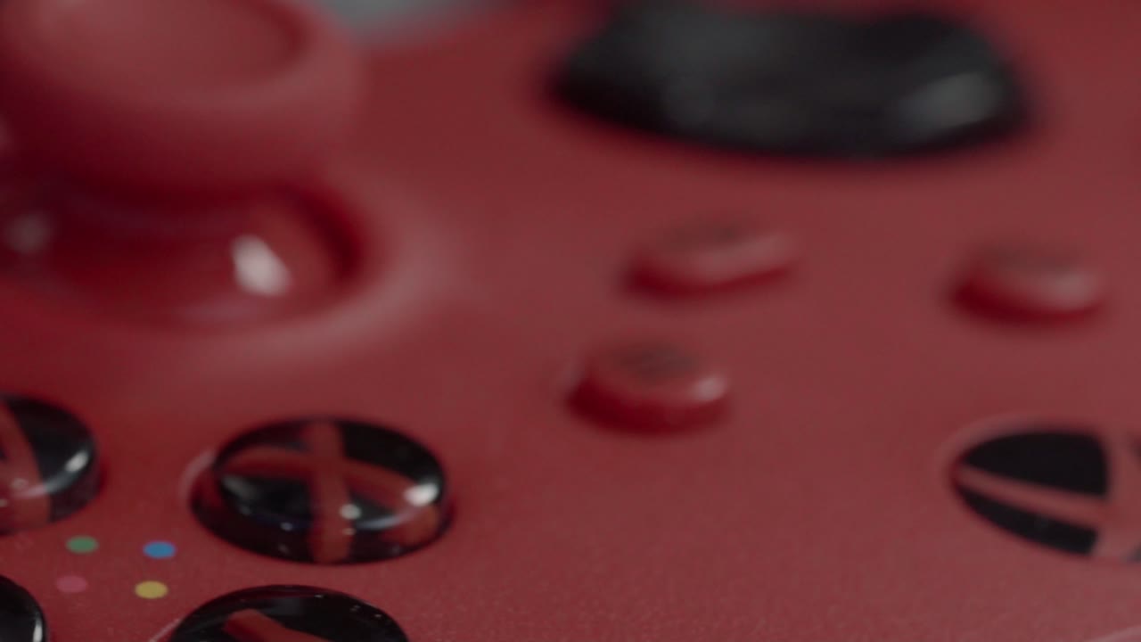 Red game controller joystick close-up; vibrant, modern, playful mood