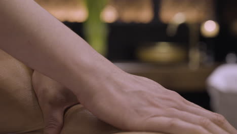 close up senseful arm and shoulder massage, whole body relaxation in beautiful spa with professional therapists, female hands touching male naked skin