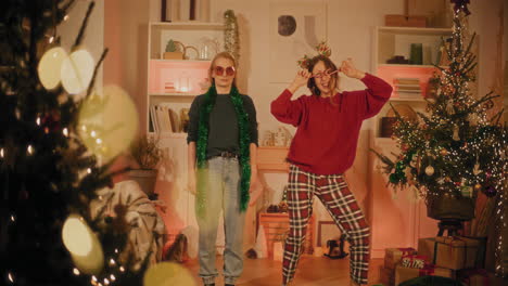 woman dancing by female friend standing in living room