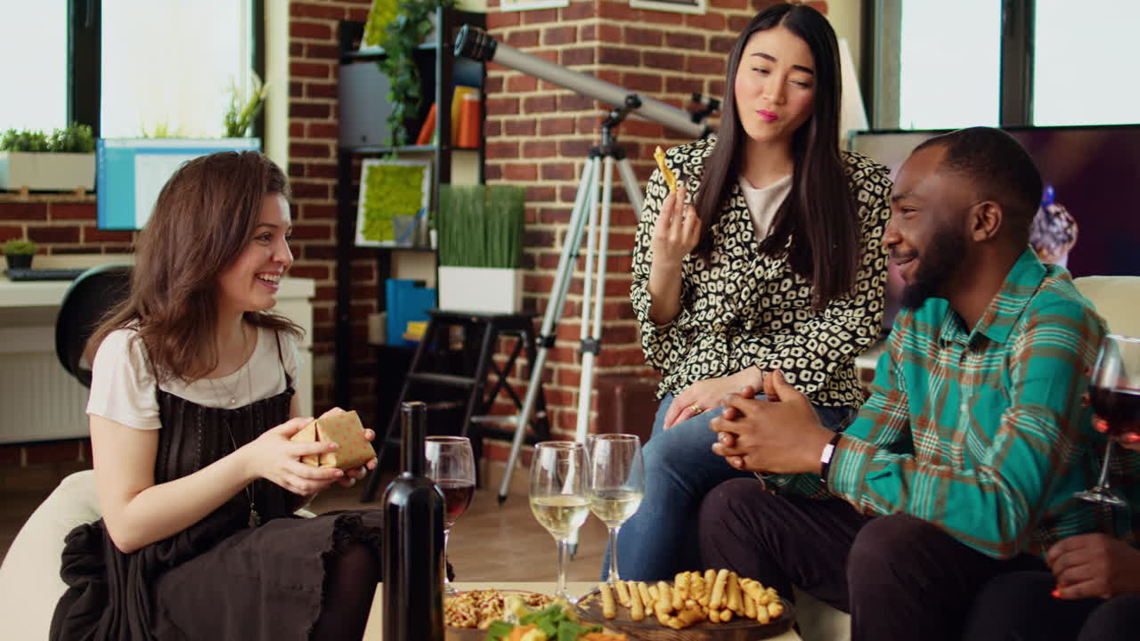 Multiethnic mates invited to birthday party offering presents to happy host impressed by gesture