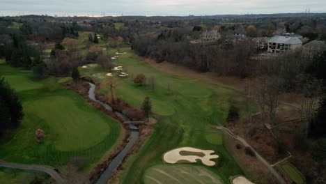 aerial drone establishing shot of an empty green golf course in toronto, ontario, canada