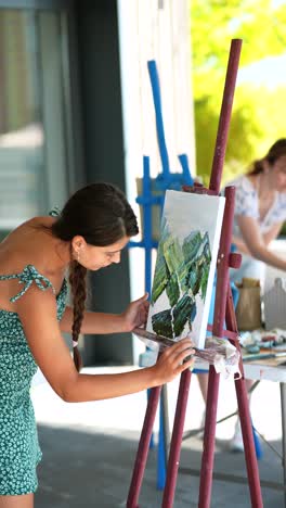 young woman painting outdoors