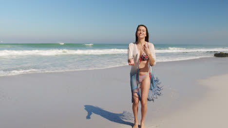 Young-woman-dancing-at-beach-4k