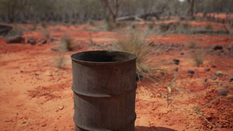 old empty rusted barrel on sand