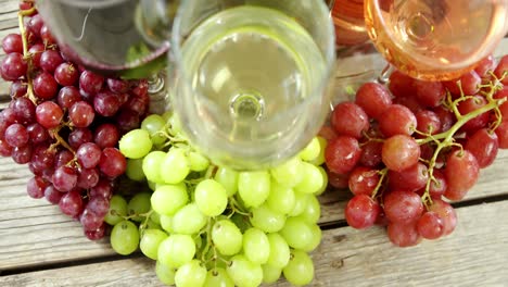 Various-grapes-and-wines-on-wooden-plank