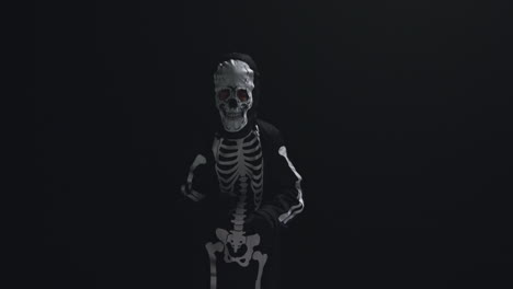 Studio-Shot-Of-Child-Dressed-Up-In-Skeleton-Costume-Trick-Or-Treating-At-Halloween-Dancing-Against-Black-Background-5