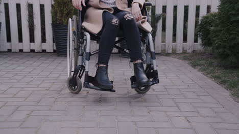 Front-View-Of-A-Woman-In-Wheelchair-Smiling-And-Looking-At-Camera