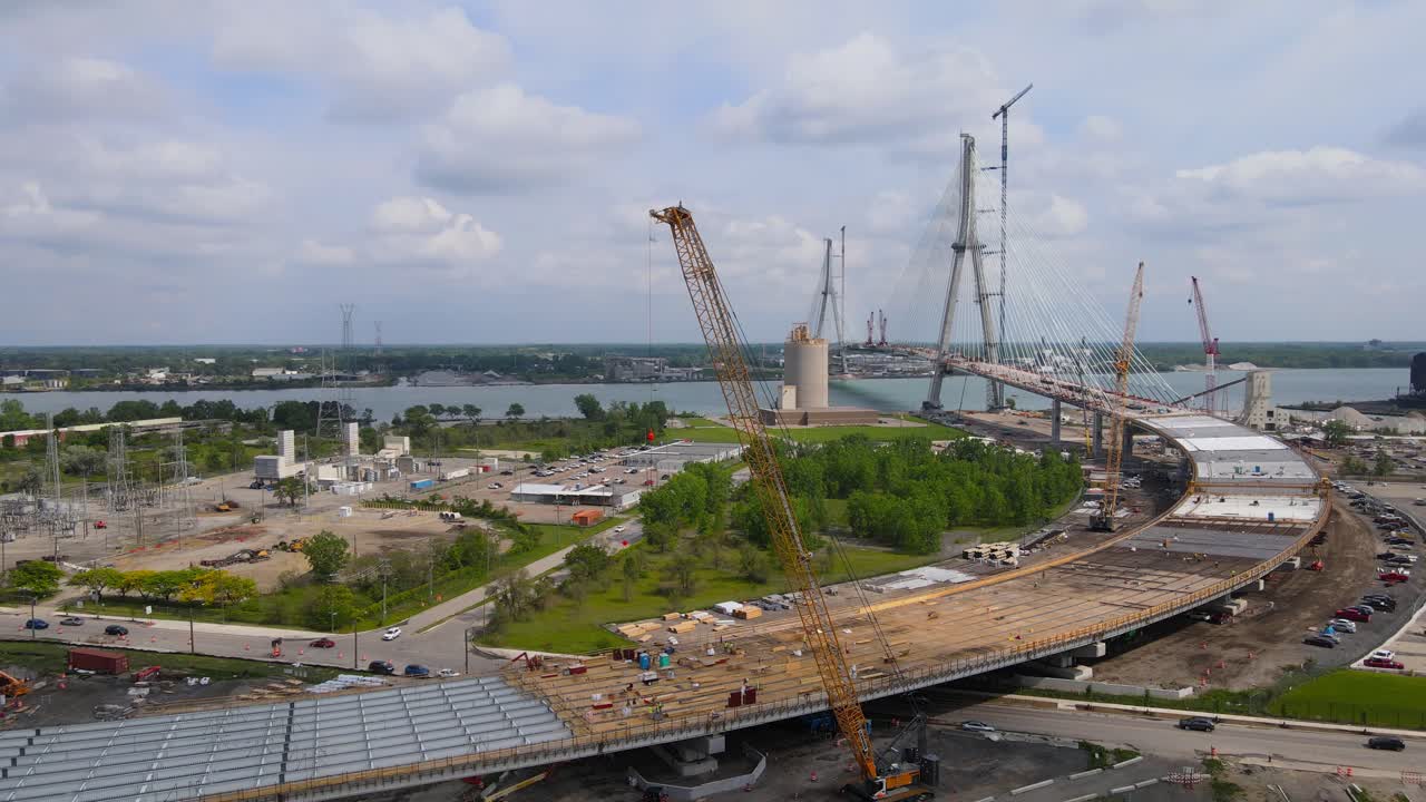 Construction site of massive Gordie Howe bridge over Detroit river, aerial view