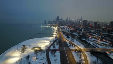 Drone-shot-over-traffic-on-the-Lake-shore-drive,-snowy-evening-in-Lincoln-park,-Chicago,-USA