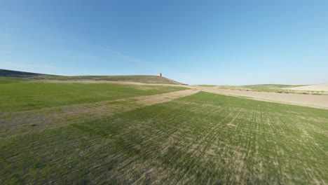 open green grassy field near mediterranean countryside in spain