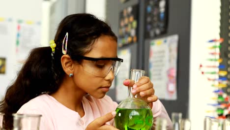 Schoolkid-examining-chemical-in-laboratory-4k