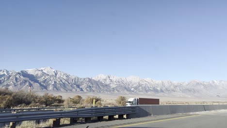 Driving-on-the-east-side-of-the-sierra-nevada-mountains,-desert-landscape