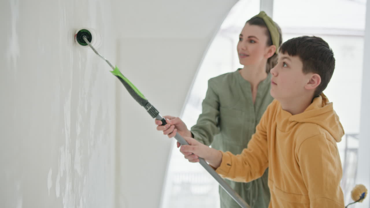 Mother and Son Painting a Wall