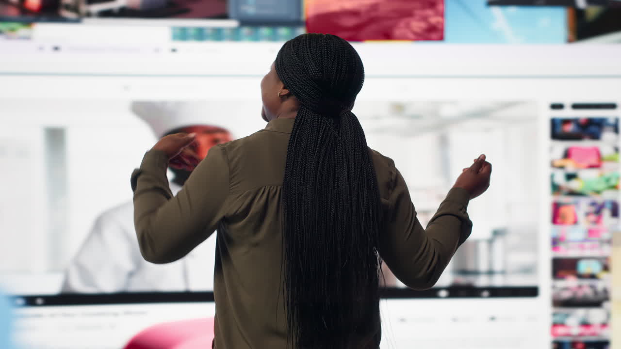 Woman looks at mixed videos mosaic mirroring modern media consumption habits