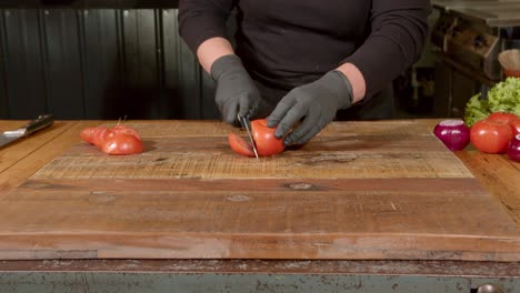 preparing juicy ripe red tomatoes by slicing them