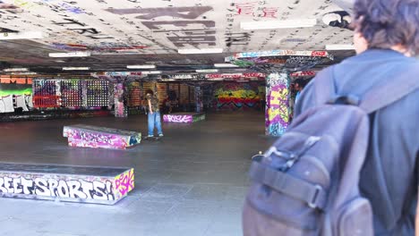 skateboarders performing tricks in urban skatepark