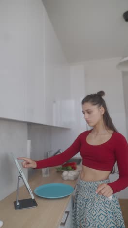 woman following online cooking recipe