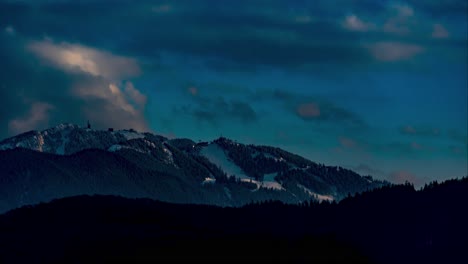 Sun-Setting-Over-Poiana-Brasov-Ski-Resort-In-Romania,-Winter-Mountain-Time-Lapse,-Fast-Moving-White-Clouds