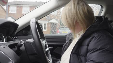 female sits down and checks out her brand new motorcar interior