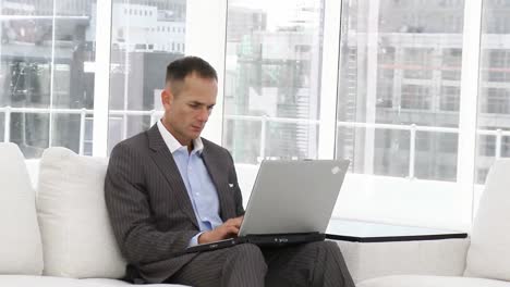 Serious-businessman-working-at-a-laptop