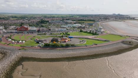 seaside town headland fairground and proposed eden project construction site. summer. marine road central, morecambe, lancashire, uk