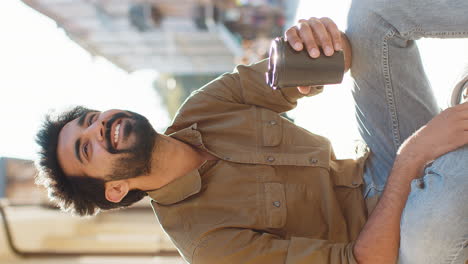 adult indian man enjoying drinking morning coffee hot drink relaxing taking a break in city street