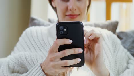 woman using smartphone at home