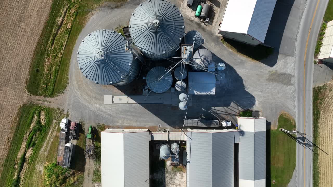 scatto aereo in discesa dall'alto verso il basso di fattoria e silos