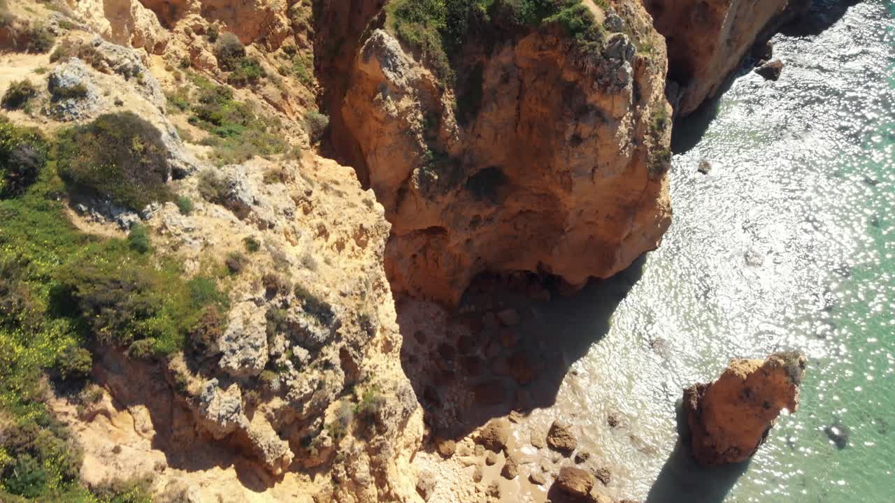 Top view of eroded cliff scarps coastline in Ponta da Piedade, Lagos, Algarve, Portugal - Aerial Birds eye view