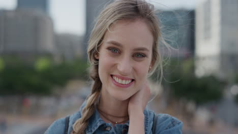 portrait-cute-young-blonde-woman-smiling-running-hand-through-hair-enjoying-relaxed-urban-day-in-city-slow-motion-feminine-beauty