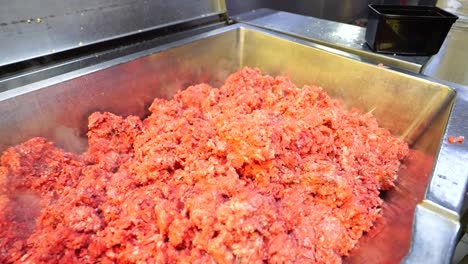 workers hands put cooked spices into a large pot at a catering food factory