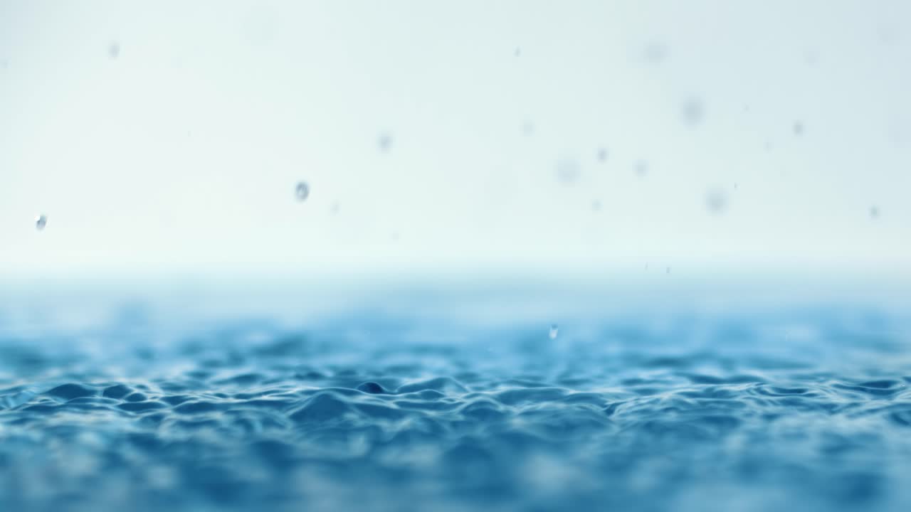Rain water drops falling in super slow motion.